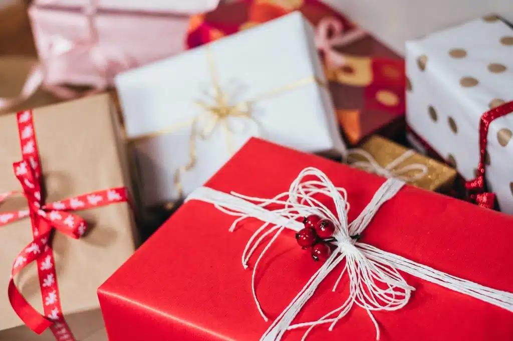 Christmas presents wrapped in an assortment of festive colours