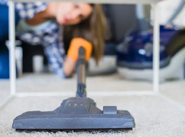 close-up-housemaid-cleaning-carpet-with-vacuum-cleaner