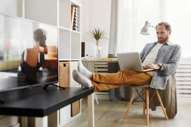 handsome-man-using-laptop-modern-interior