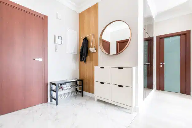 modern-fresh-white-hallway-interior-entrance-door-wooden-hanger-with-hanging-clothes-lady-s-purse-there-are-shoe-cabinet-near-door-round-mirror-wall