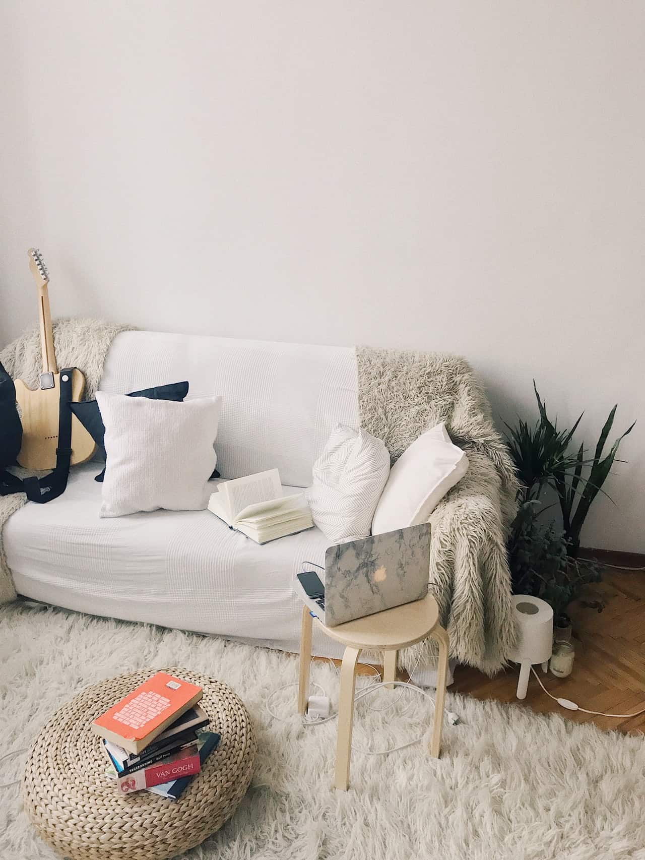 A living room with laptop and guitar