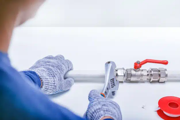 Plumber checking water pipes leak