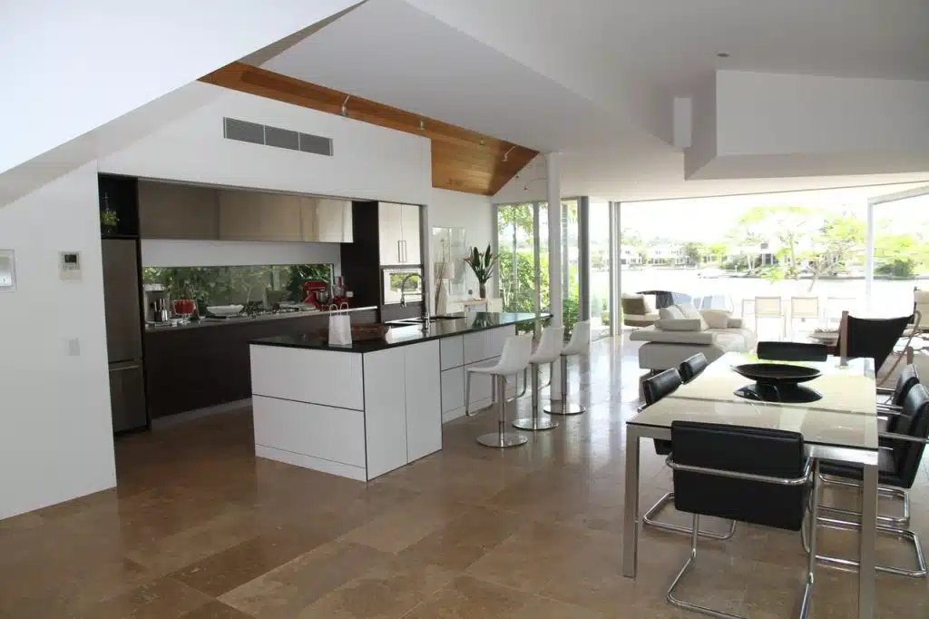 Modern designed open plan kitchen with bar and stainless steel fridge