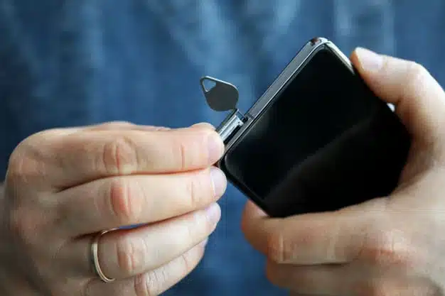 Male hands getting sim card slot