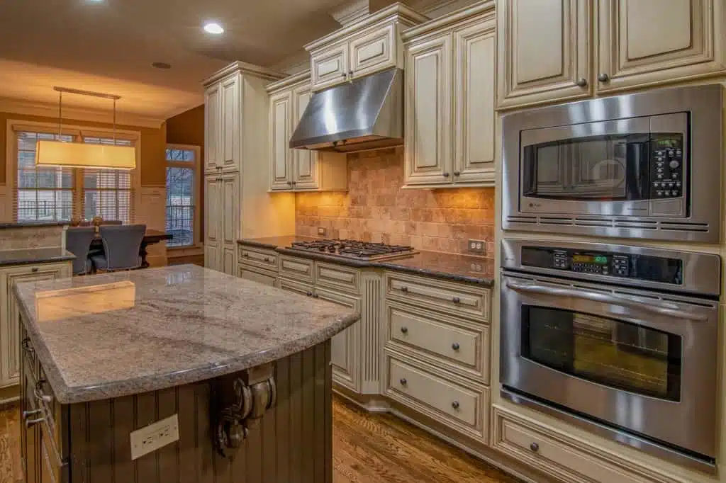 A modern kitchen with stainless steel microwave, stove, and oven