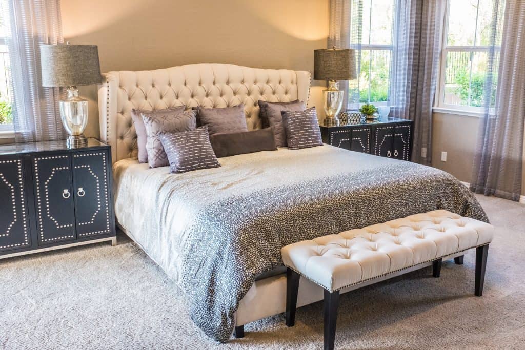 A white king size bed in a white inspired room