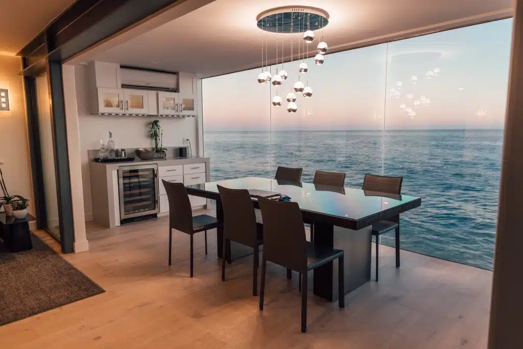 An oceanside dining room with an art nouvea chandelier