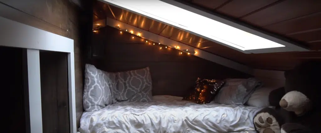 Newly renovated attic with a bed and a large fluffy teddy bear