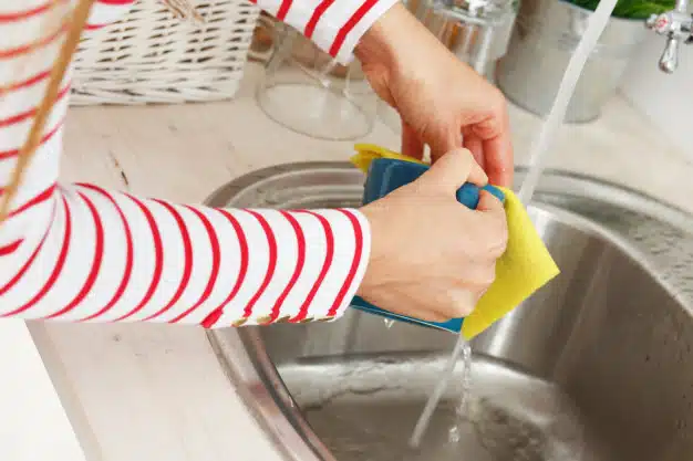 Woman washes tea cup