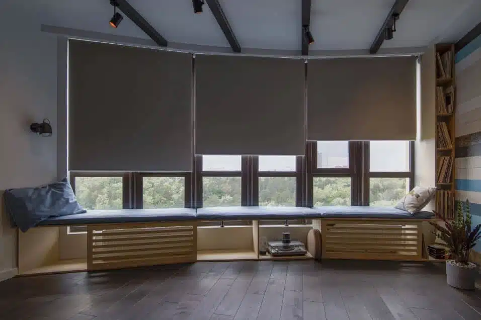 Roller blinds half way down a window in a home study