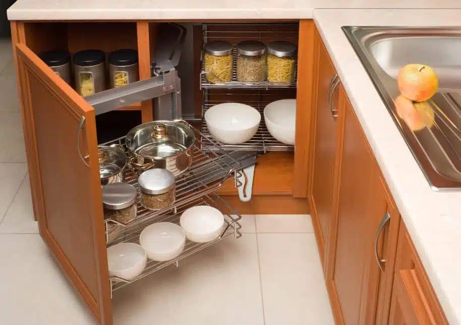 Light coloured wood kitchen cabinets filled with non-perishable food