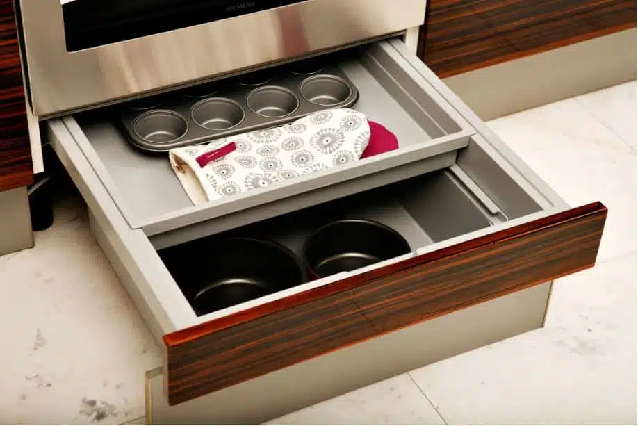 Wooden kitchen cabinets filled with baking trays