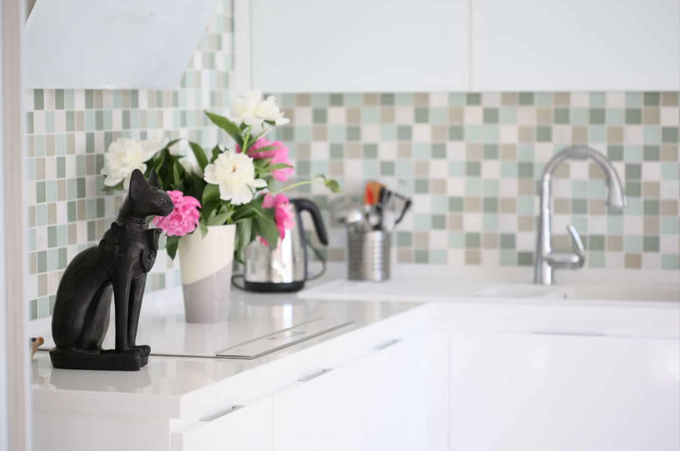 well designed white kitchen with quartz counter top