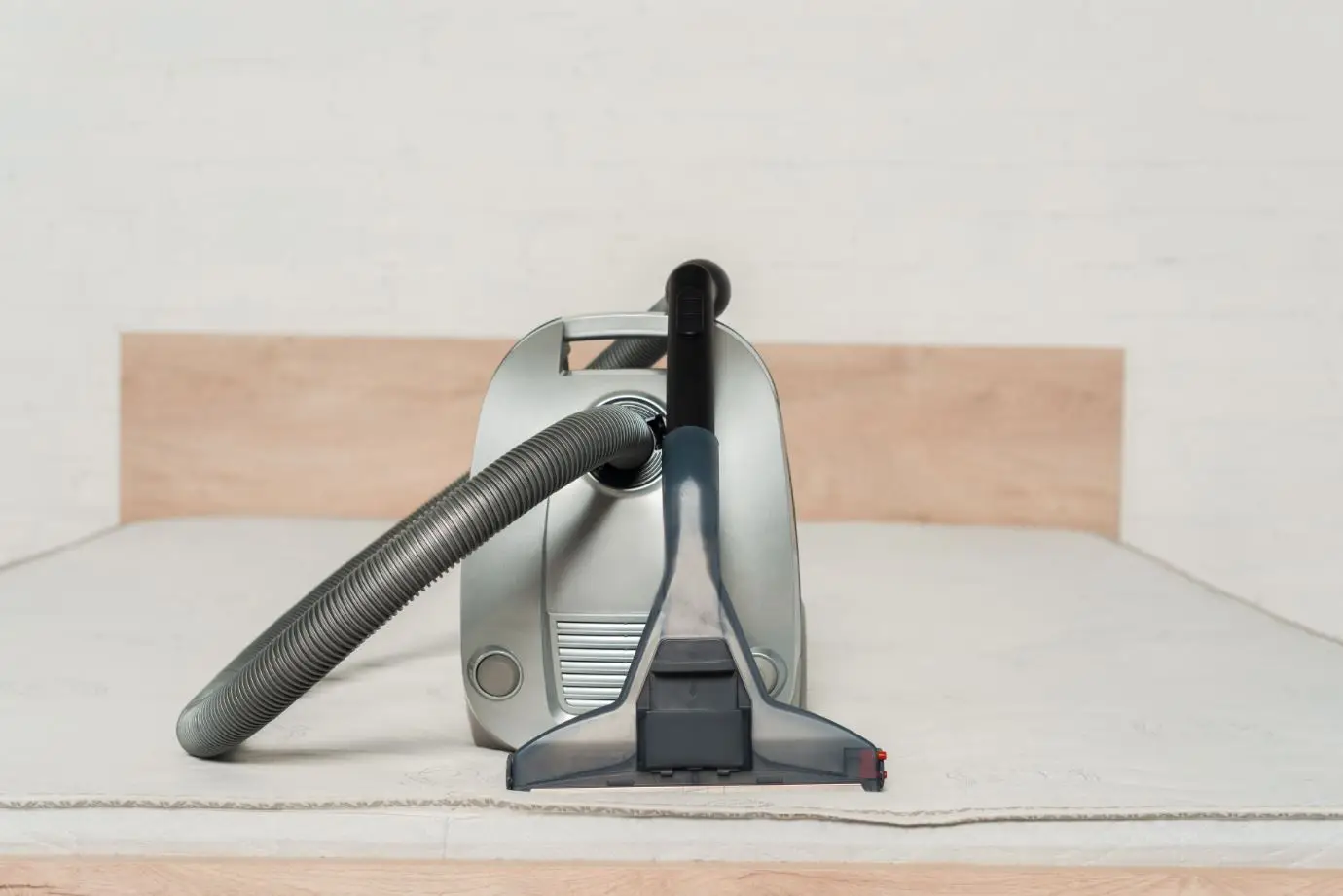 vacuum sitting a top of a mattress