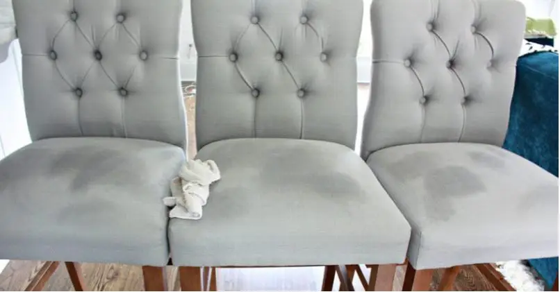 water drying on a grey upholstered chair