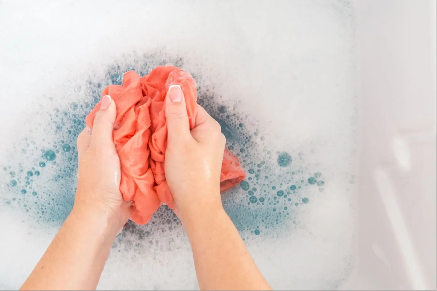 woman hand washing clothes in a sink