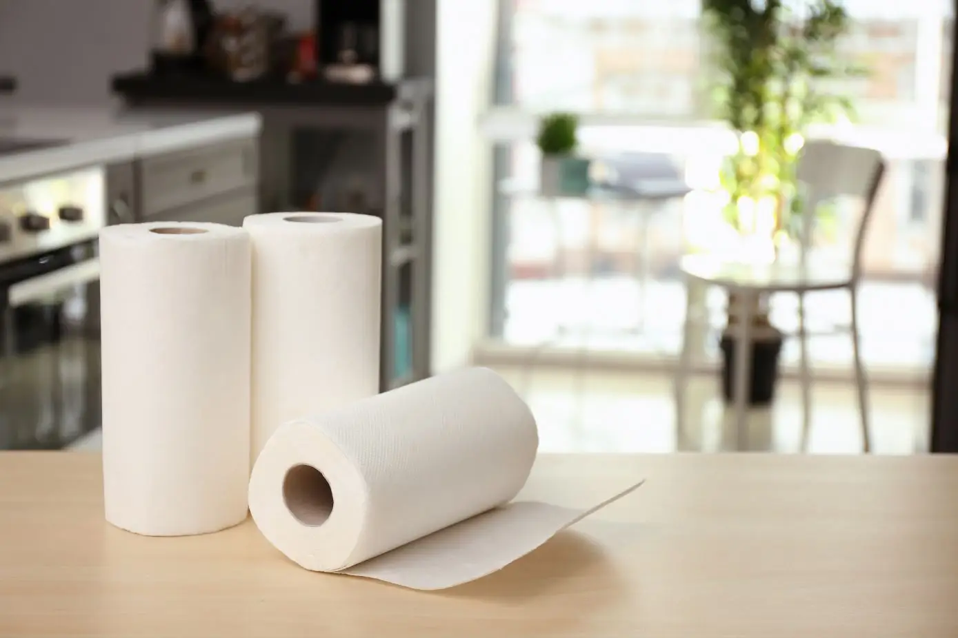 3 white paper towels on a wooden benchtop