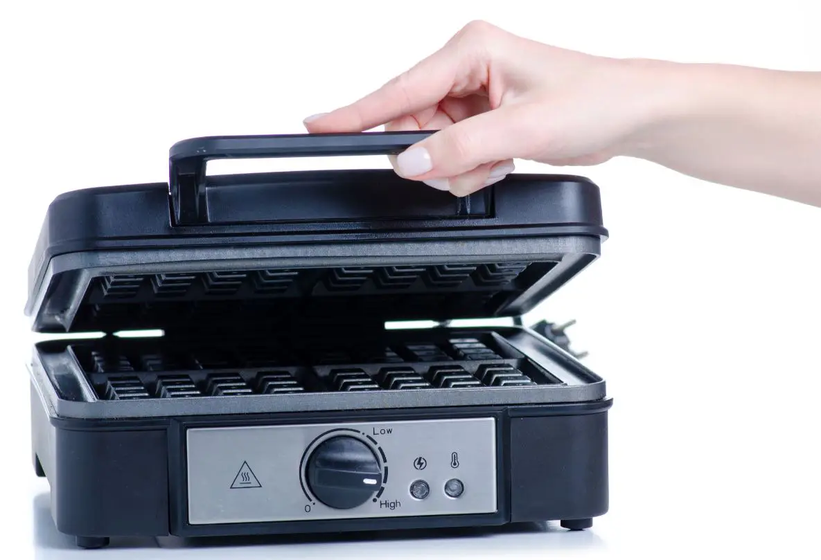 woman holding electric waffle maker