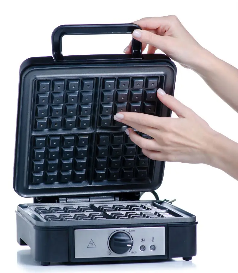 woman holding large electric waffle maker