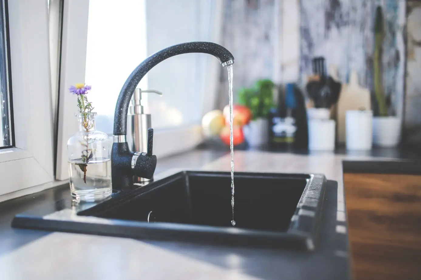 black matte plated sink with the faucet running