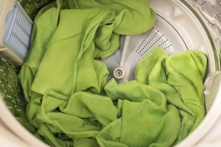 green microfiber towels in top loader washing machine drum