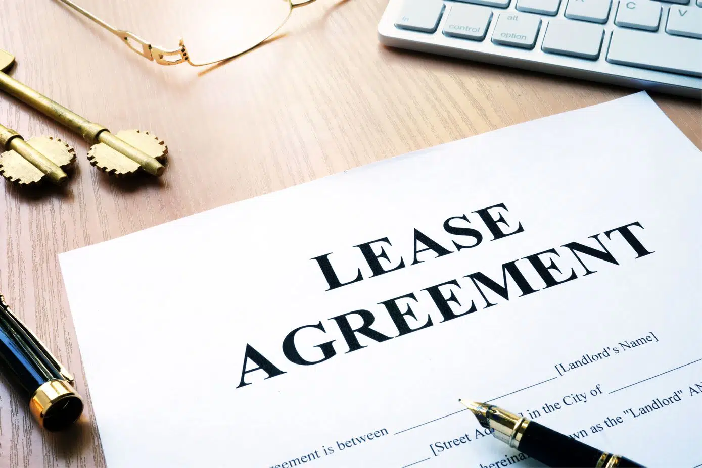 rental lease agreement form on a desk next to a chrome coloured keyboard