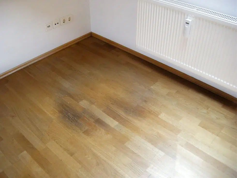 top view of a timber floor that has been discoloured and damaged from overuse