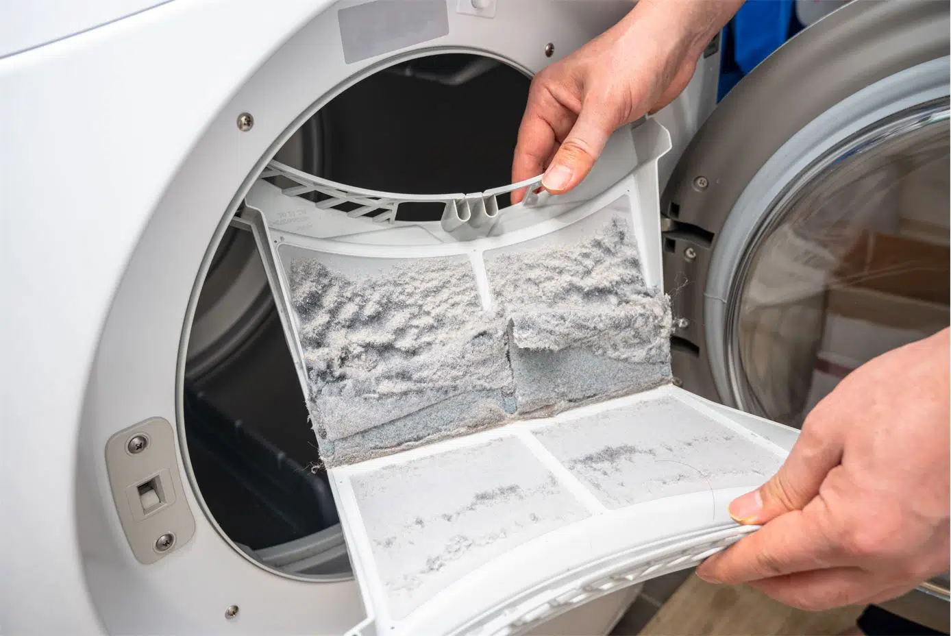 man showing full lint trap of a dryer