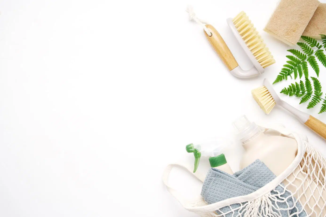 assorted eco-friendly cleaning products on a white background