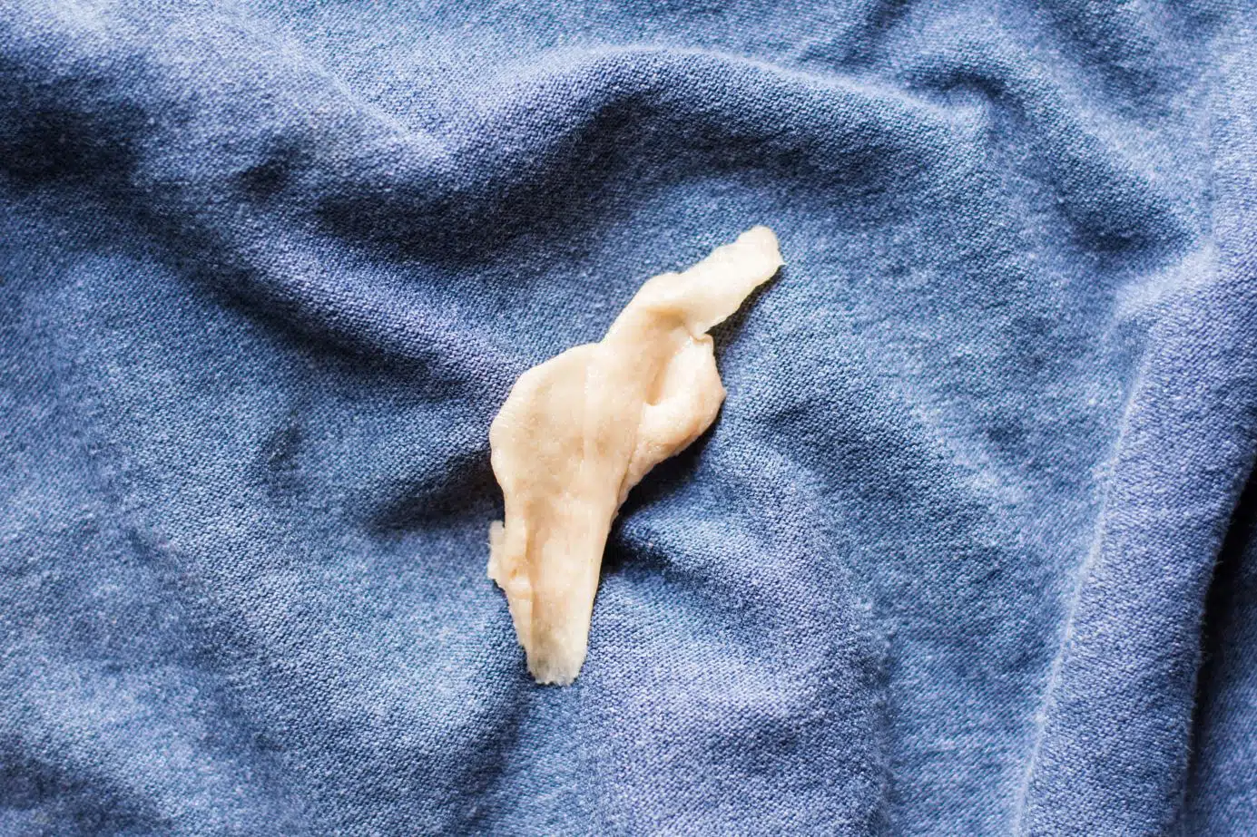 white chewing gum on a blue scarf