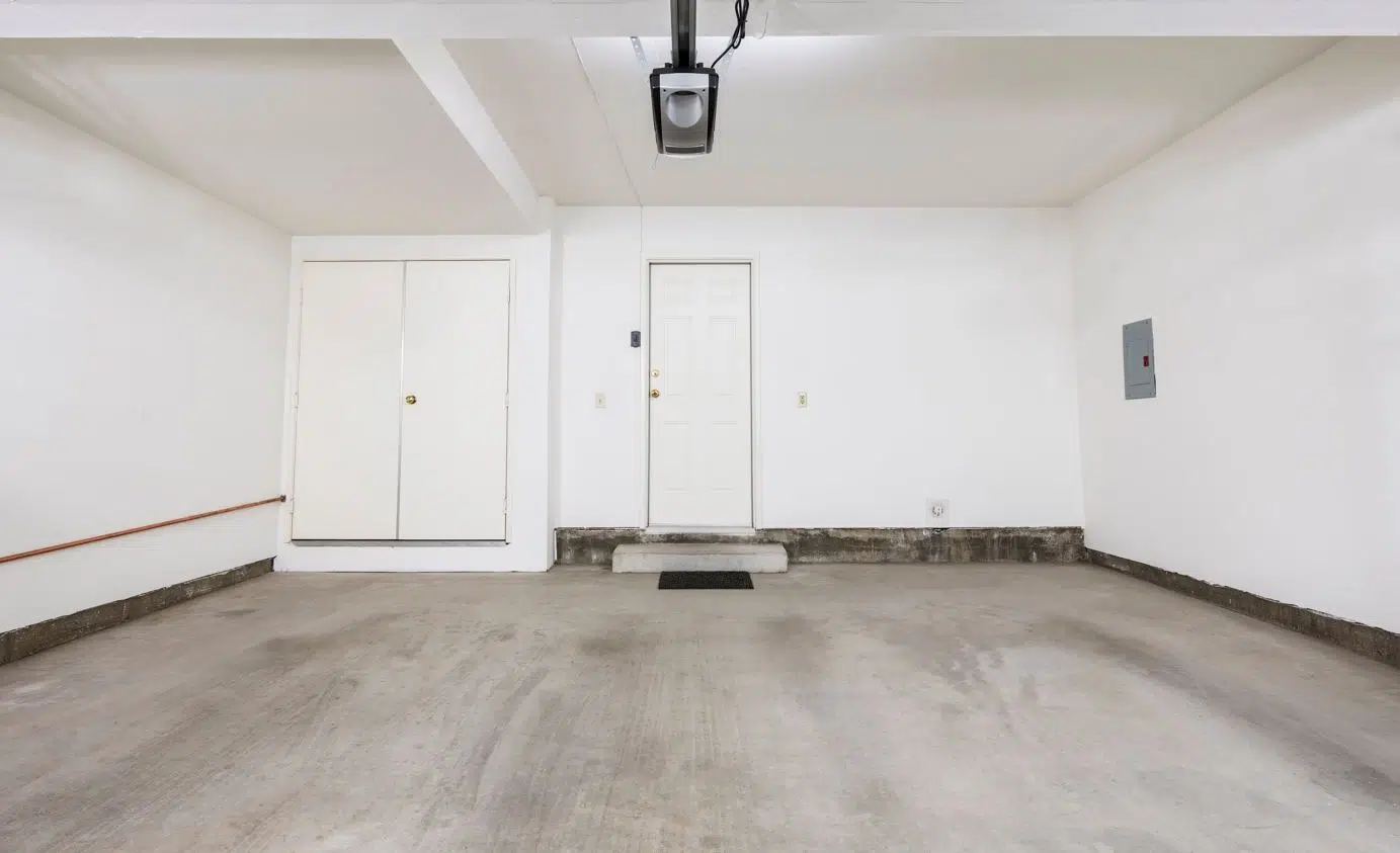 large opened space garge with a dirty concrete floor