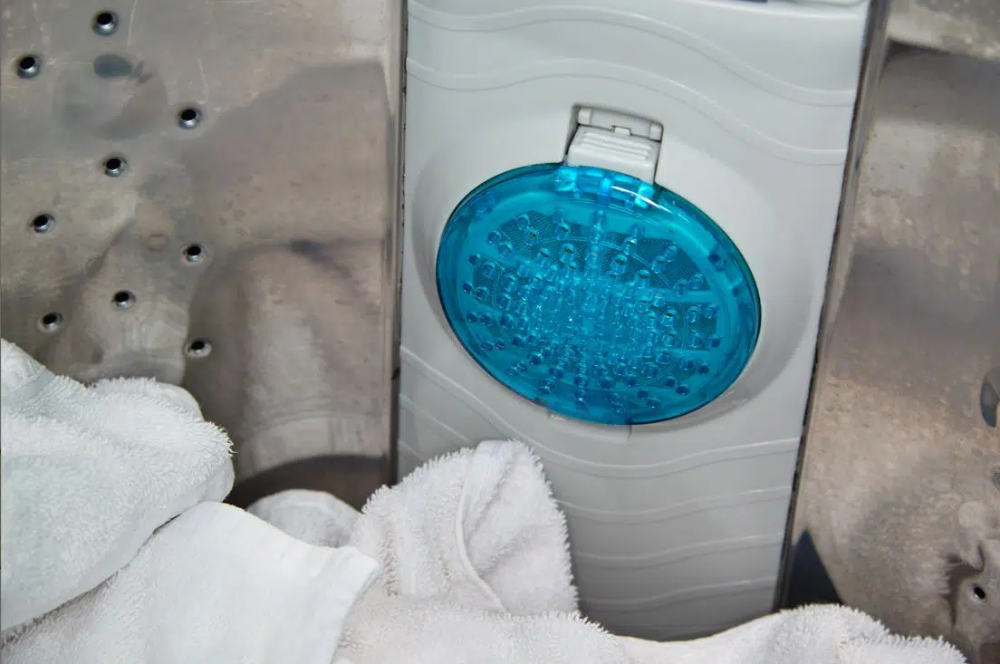 blue washing machine filter in stainless steel washing machine drum