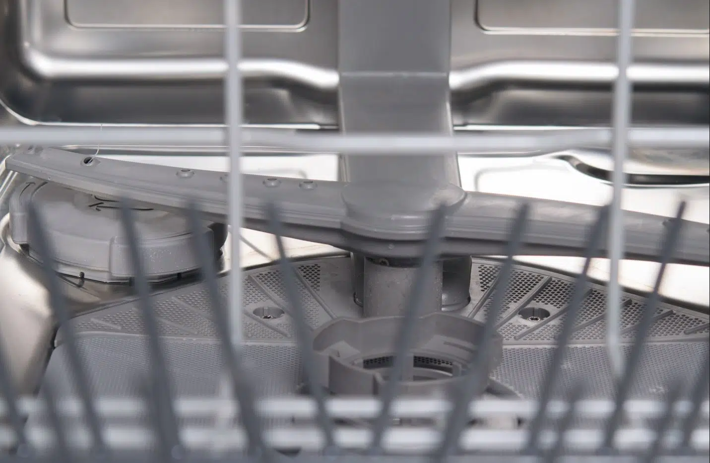 close up of the inside of the bottom of a dishwasher