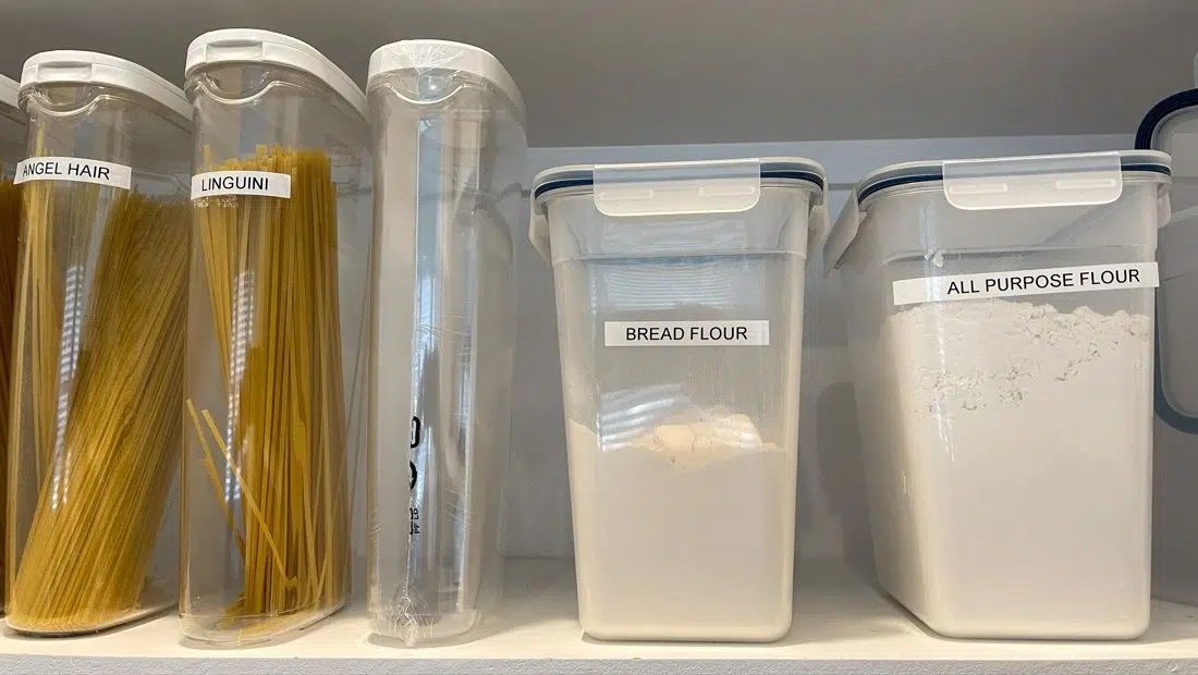 pasta and flour sorted into individual large plastic containers