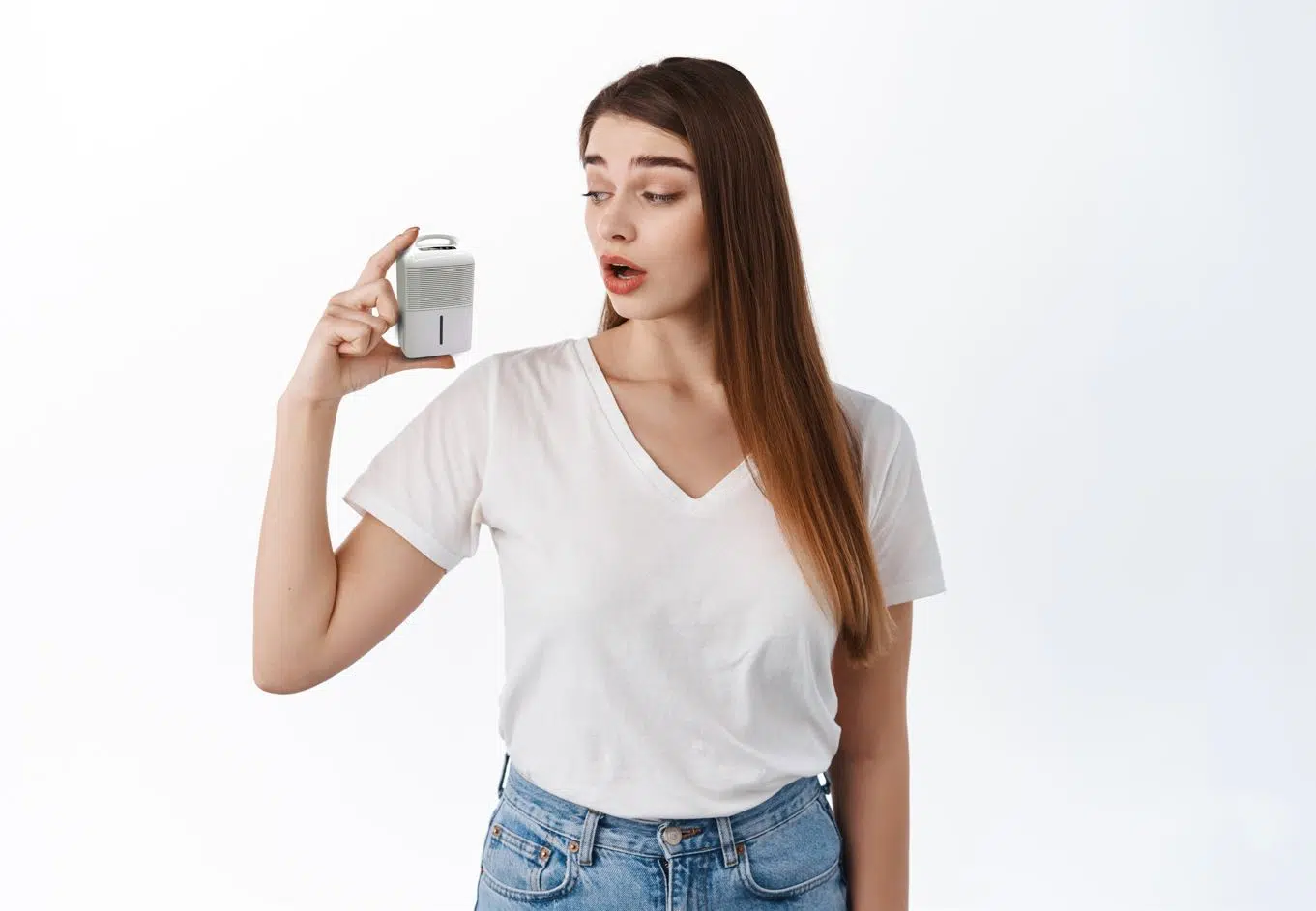 woman wearing white shirt using hand to measure size of dehumidifier