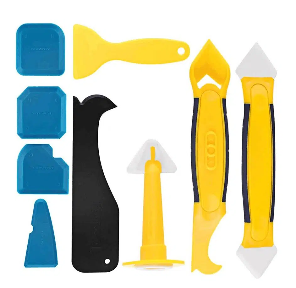 5 tools used for removing caulk on a white background