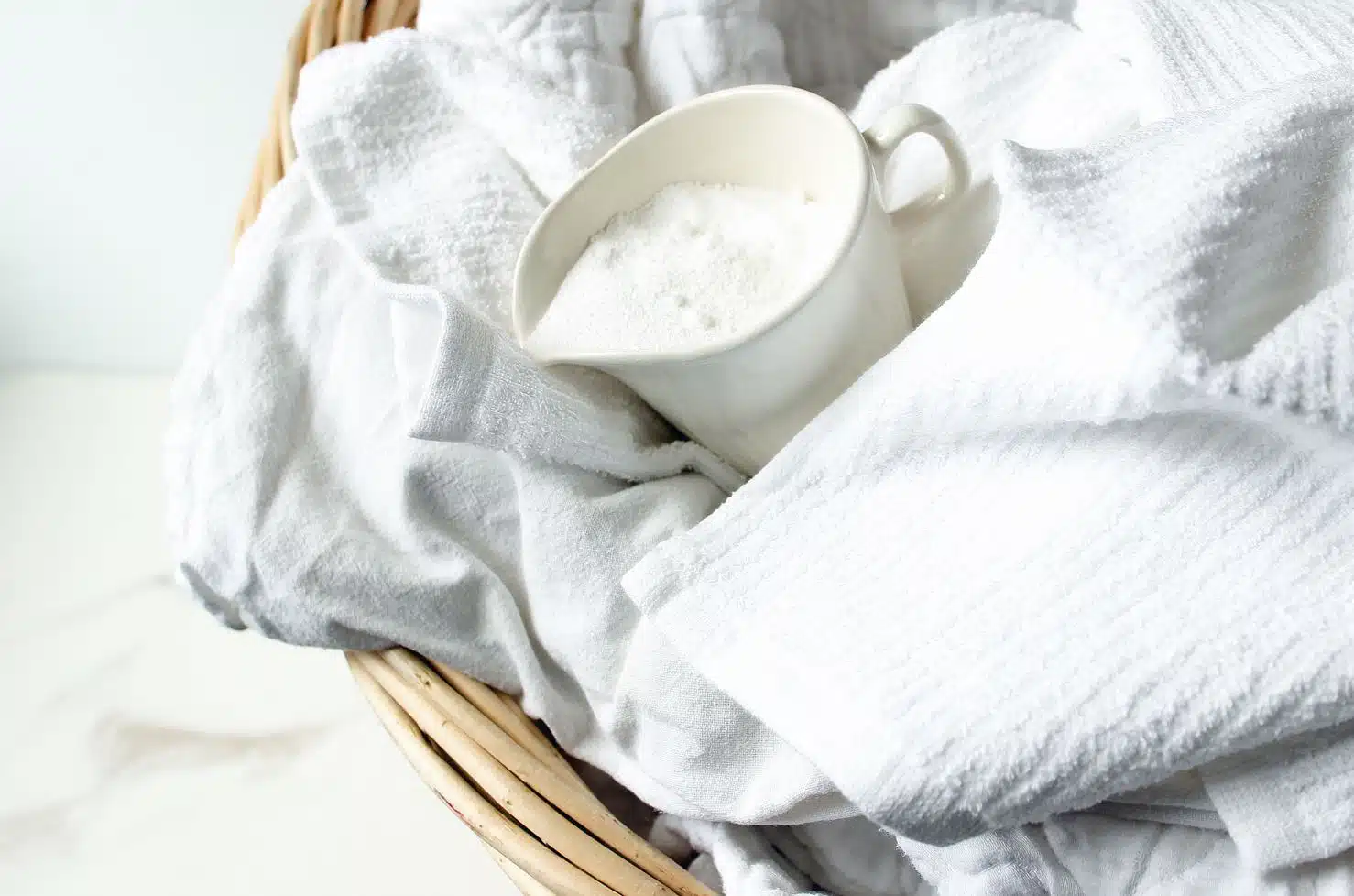 laundry basket filled with white towels