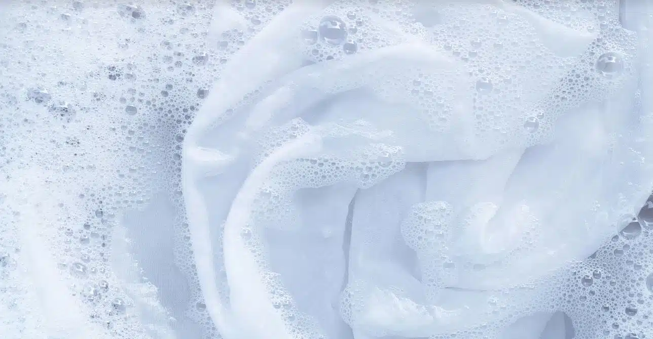 white shirt being washed in soapy water