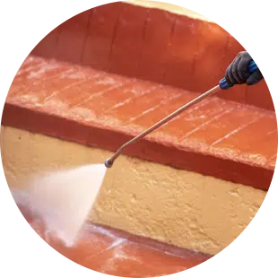 Jun using high pressure to clean brick steps