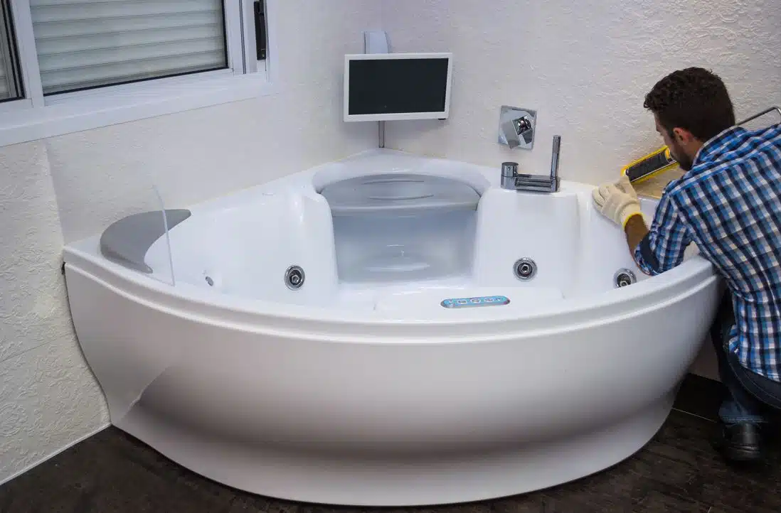 handyman fixing silicone on jetted tub