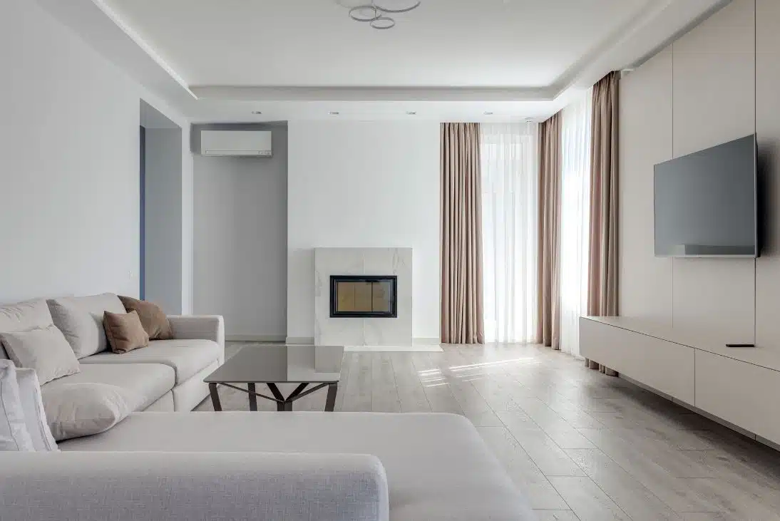 sleek modern living room with engineered timber floor boards and fireplace in the background