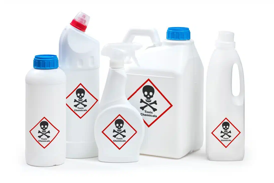 assorted cleaning chemicals marked toxic on a white background