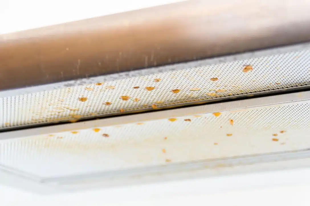 close up of grease dropping from a dirty rangehood filter