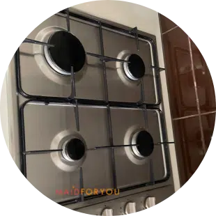 top view of 4 burner stainless steel gas cook top after being cleaned