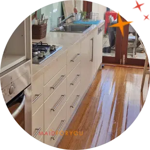 all white kitchen after being cleaned with balcony windows in the background