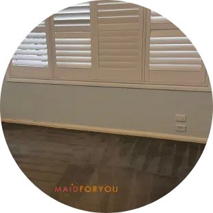 grey carpet with wand marks after being steam cleaned with closed shutters in the background
