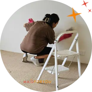 close up of maidforyou cleaner chuka cleaning white walls with a white cloth