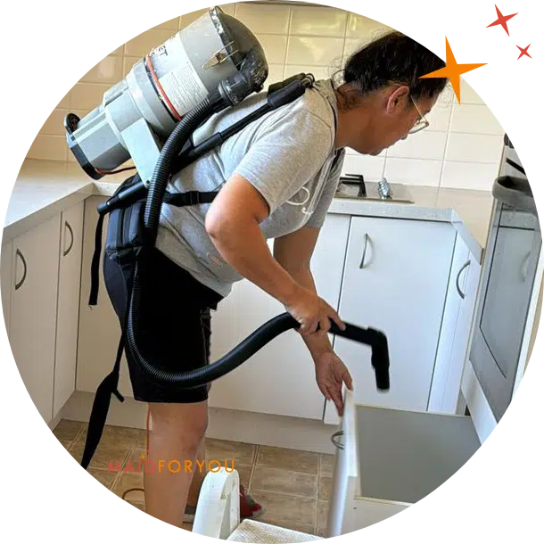 Maidforyou cleaner Zaya cleaning kitchen while wearing backpack vacuum