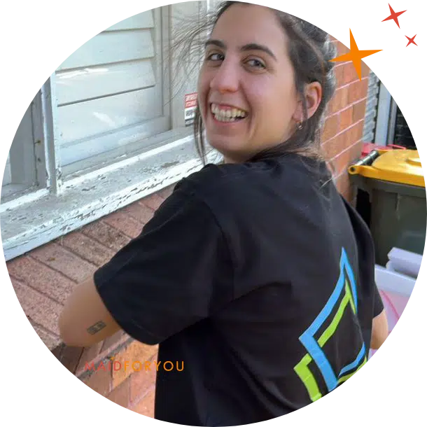 Maidforyou cleaner Gaby smiling while cleaning exterior windows