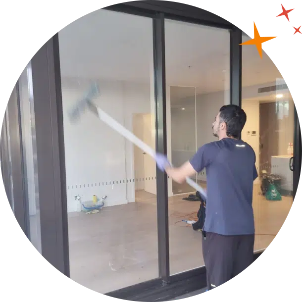 Maidforyou cleaner jonathan using an extended squeegee to clean balcony glass window